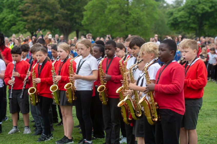Children play saxophones and clarinets at Big Sing event.