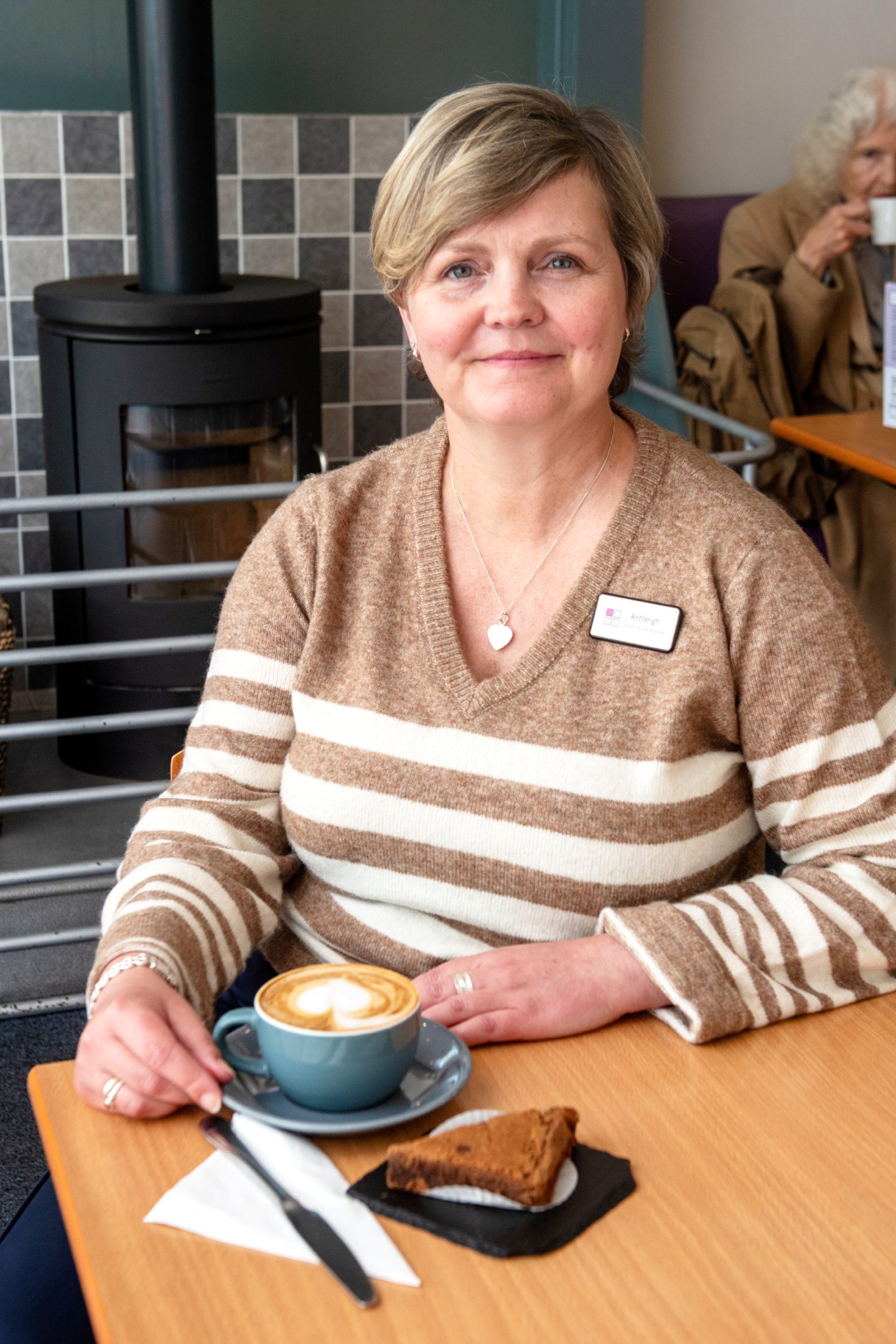 Aboyne Corner House manager Ashleigh sitting in the tearoom with a coffee and cake