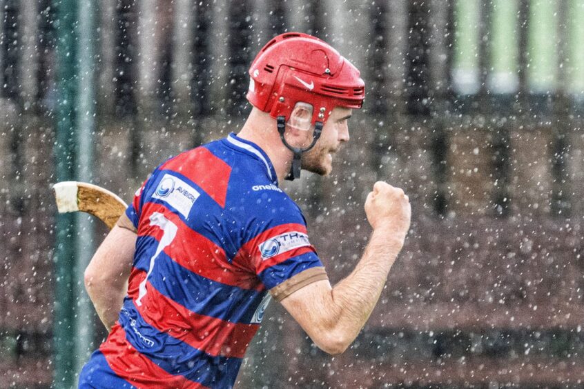 Kingussie's Lee Bain puts the icing on the cake with the third goal against Skye during a second half downpour. Image: Neil G Paterson.