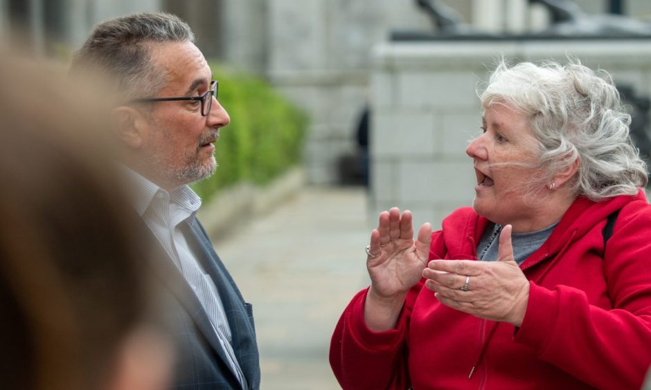 Aberdeen City Council co-leader Christian Allard speaks to Torry residents ahead of this morning's council meeting. Image: Kami Thomson/DC Thomson