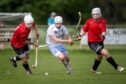 Lovat's Lewis Tawse (left) and Callum Cruden close in on James Morrison (Skye). Image: Neil Paterson.