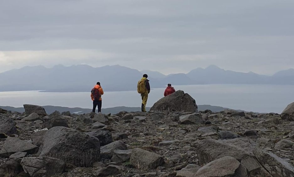 Lochaber MRT members on the Isle of Rum looking out onto the water.