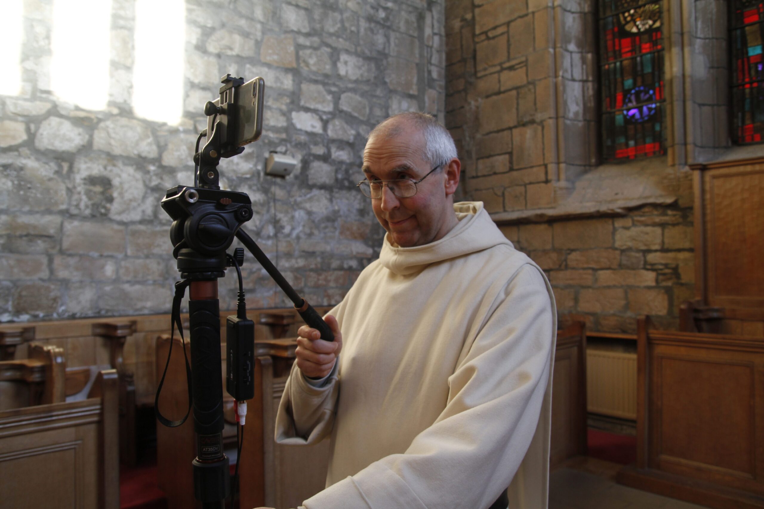Monk behind video camera. 