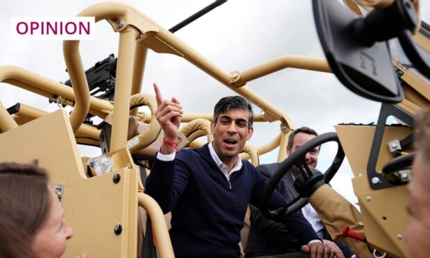 Prime Minister Rishi Sunak examines Jackal armoured vehicles during his visit to defence vehicle manufacturer Supacat in Exeter. Image: Aaron Chown/PA Wire