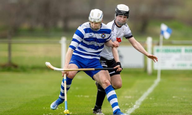 Newtonmore's Rory Kennedy in front of Graeme MacMillan (Lovat). Image: Neil Paterson.