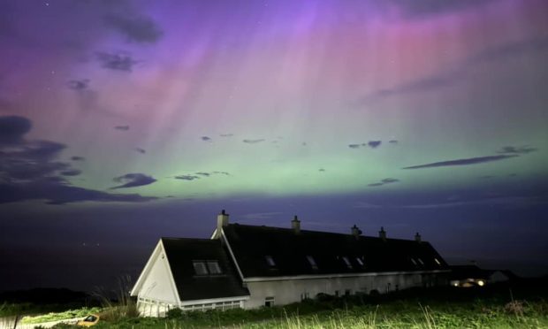 Northern Lights over a bungalow in Cove Bay.