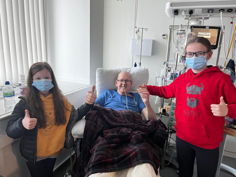 Hugh Sutherland in hospital for cancer treatment with granddaughters Allie and Penny. 