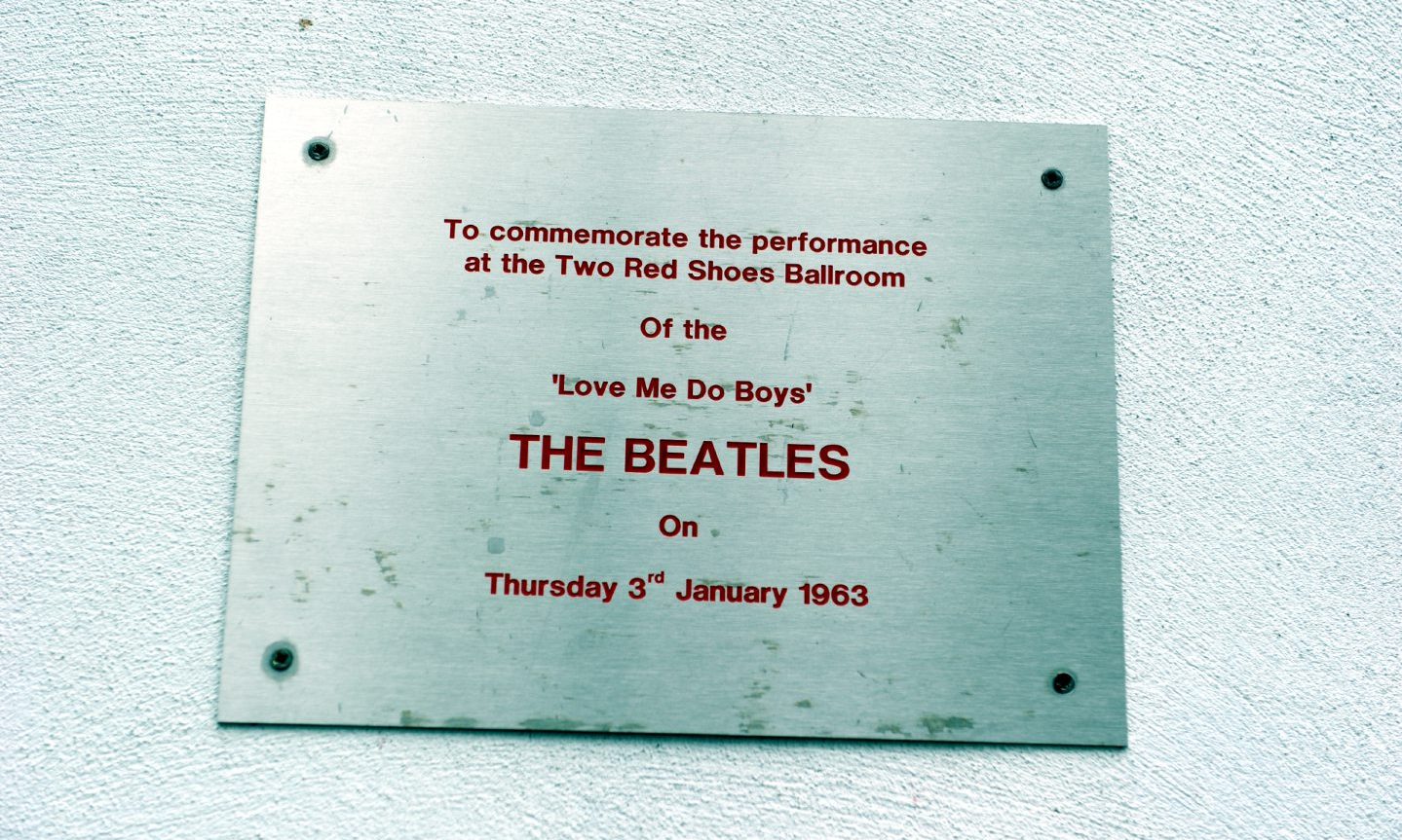 Silver metal plaque commemorating Beatles gig in Elgin. 