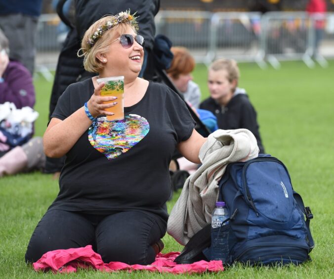 A woman enjoying a drink at the festival