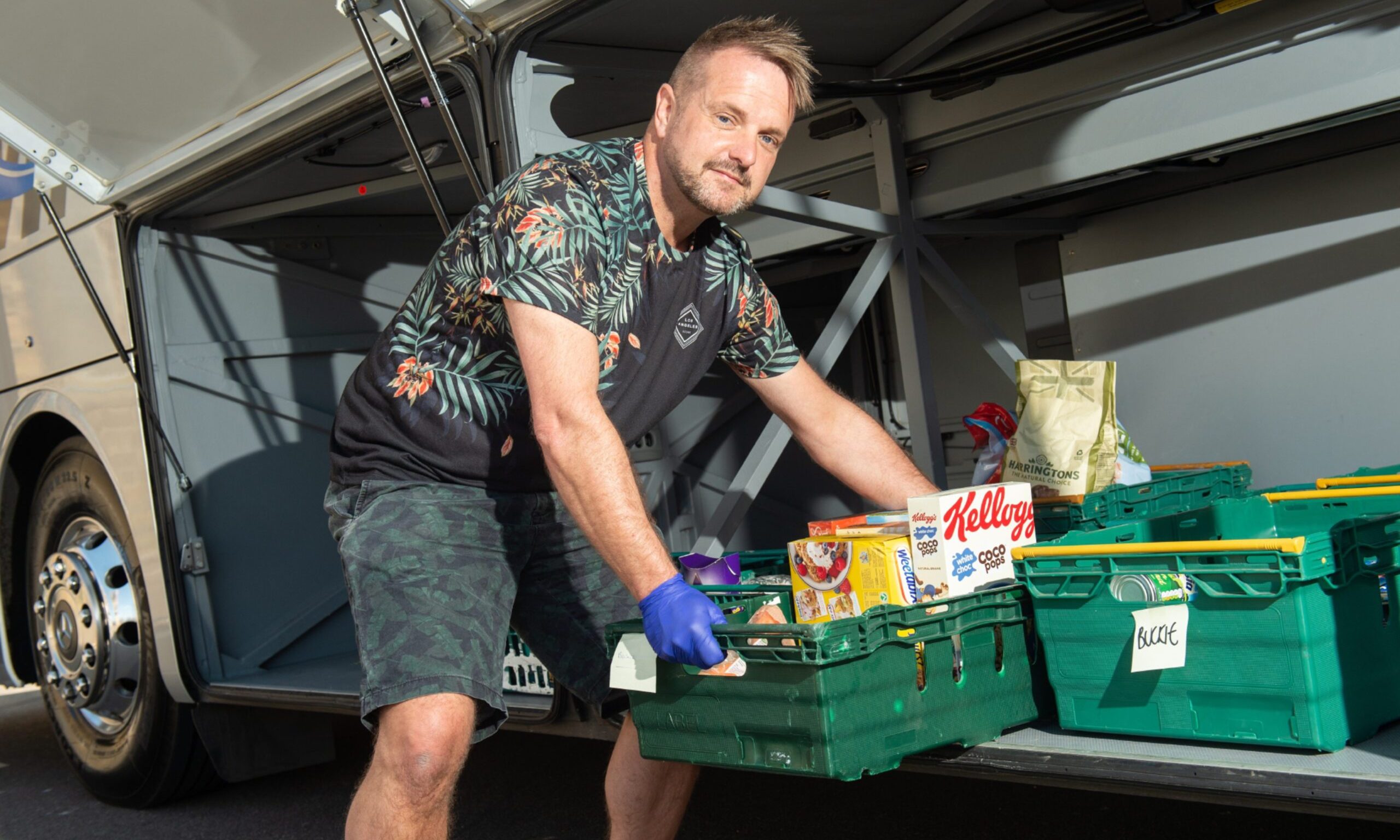 John Stuart lifting food out of coach. 