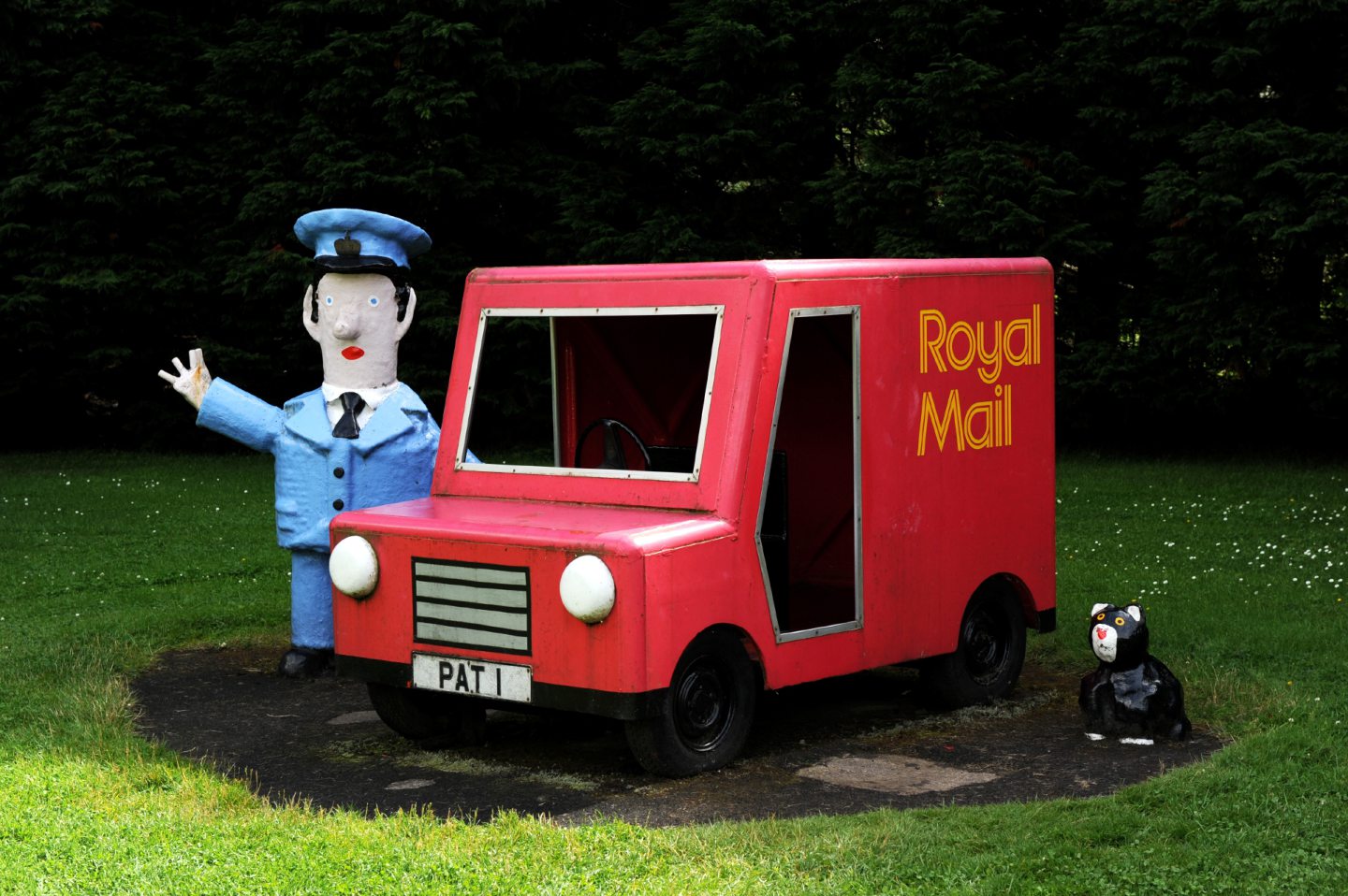 The Postman Pat and Jess figures standing next to his postvan