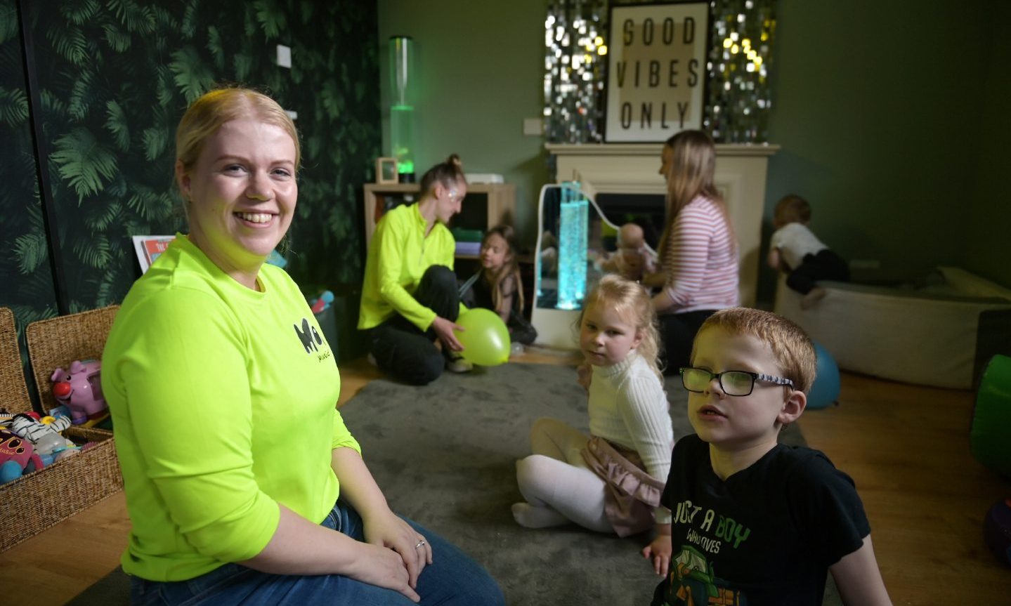 Leanne Shand inside Fika playroom with children. 