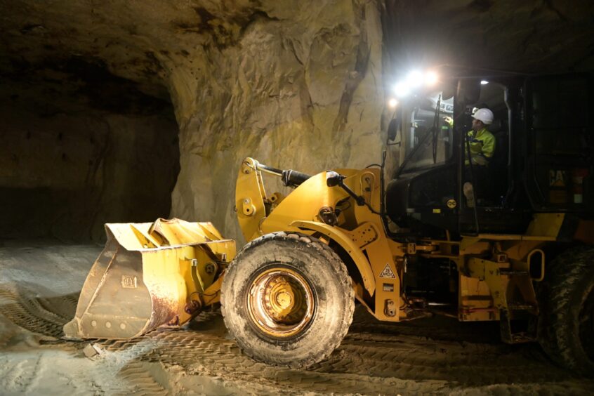 An excavator at work deep in the Lochaline mine