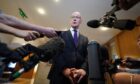 First Minister John Swinney arrives to speak to the media in the Scottish Parliament at Holyrood, Edinburgh. Image: PA