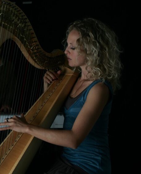 Ruth playing her harp in concert.