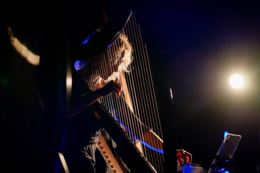 Ruth with her harp in concert.