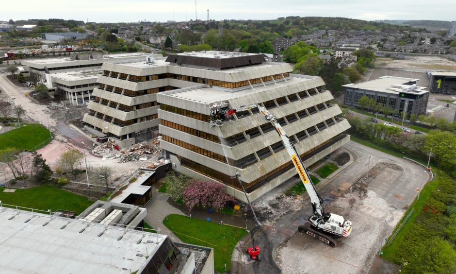 Diggers tearing down the main Shell HQ building in Aberdeen.