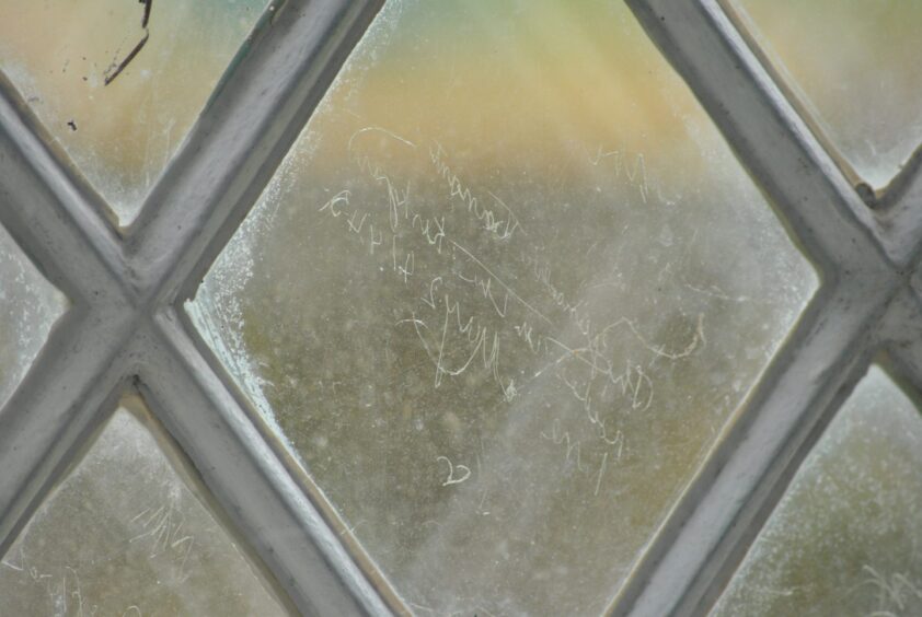 Scratchings on windows of Croick church in the Highlands, which some say are connected with the Clearance of Glencalvie.