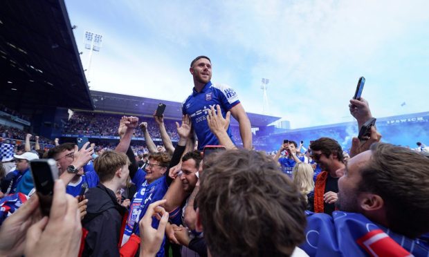 Wes Burns of Ipswich Town celebrates promotion with fans at the end of Saturday's 2-0 win against Huddersfield Town. Image: Shutterstock