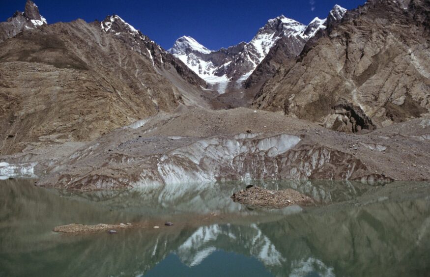 View of a mountain known as Muztagh Tower, and a glacial pool in the Baltoro Muztagh region of Pakistan.