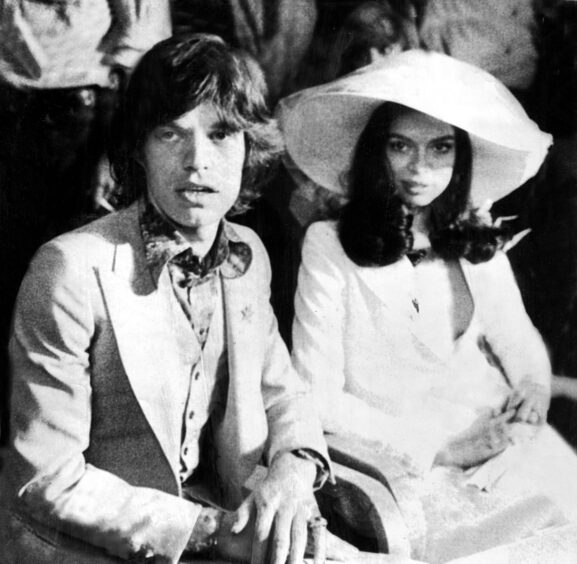 Mick Jagger seated in church next to Bianca during their wedding in St Tropez in 1971.