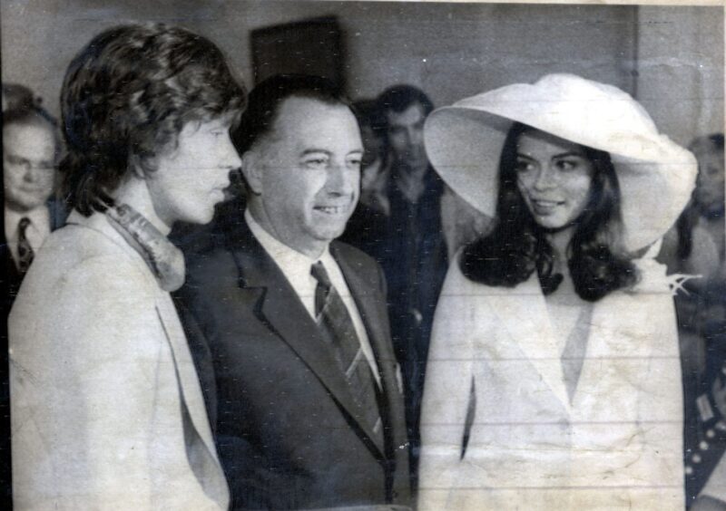 Smiling St Tropez mayor Marius Astezan flanked by Mick Jagger and Bianca during their 1971 wedding ceremony.