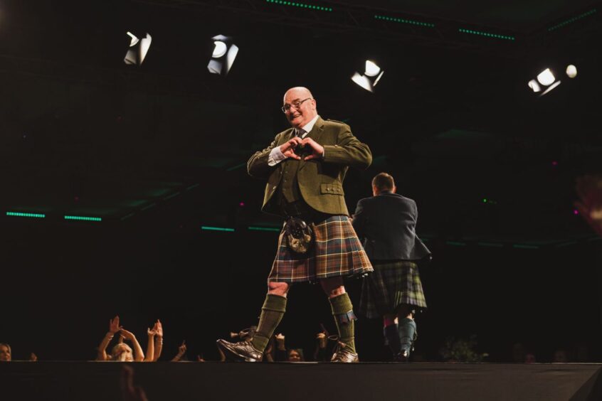 Brian Noble on the catwalk in his kilt 