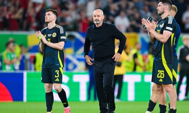 Steve Clarke, Andy Robertson and Scott McKenna look dejected after defeat against Hungary. Image: Shutterstock.