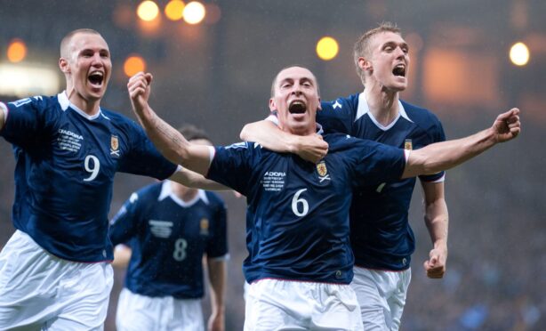 Scott Brown (6) and his team mates Kenny Miller and Darren Fletcher (right) celebrate after his goal puts Scotland into the lead against Macedonia. Image: SNS