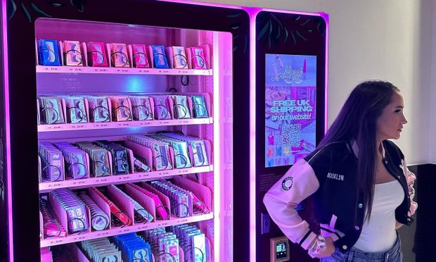 Meggi Morgan standing next to vending machine in Inverness