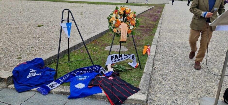 Wreaths and football shirts left at Dachau Concentration Camp.