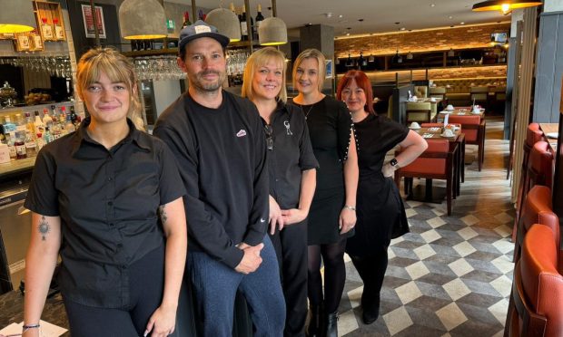 Jamie Dornan posing with staff at The Garrison Hotel in Fort William. Image: The Garrison Hotel.
