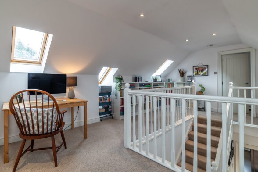 Versatile and bright upstairs landing at Struan House at Mill Of Crynoch, with room to work or study and lots of storage.