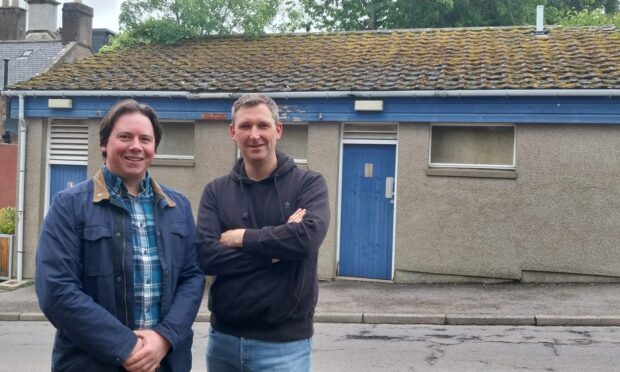 Peter Clark and David Sutherland of the Auchenblae Parks Committee next to the village toilets