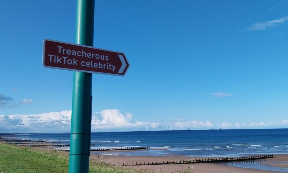 Sign at Aberdeen beach: "Treacherous TikTok celebrity"