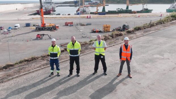Four staff members on dock at Port of Aberdeen.