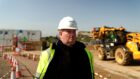 man wearing hard hat in a construction site is featured in film about mental health in construction industry