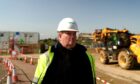 man wearing hard hat in a construction site is featured in film about mental health in construction industry