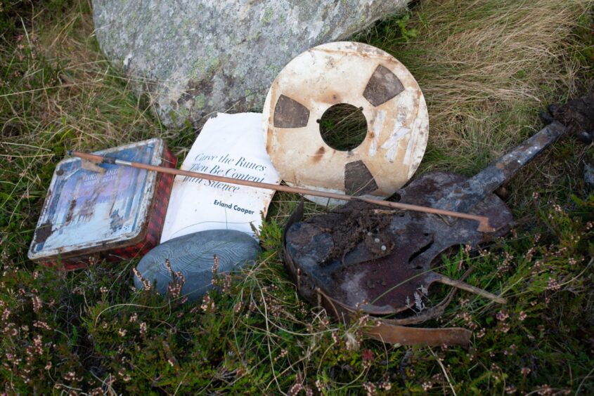 The unearthed tape, biscuit tin and violin in Orkney. 
