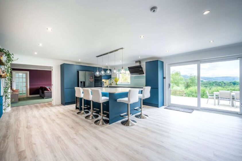Open plan kitchen with blue and white units.