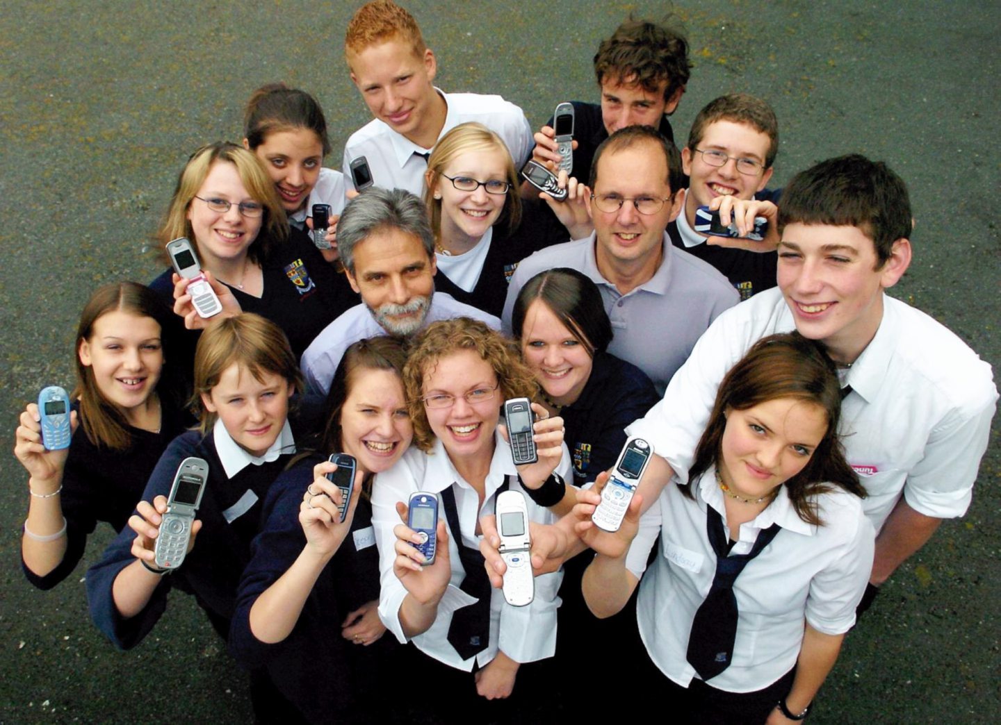 Inverurie Academy pupils posing for photos holding mobile phones for an anti-bullying scheme