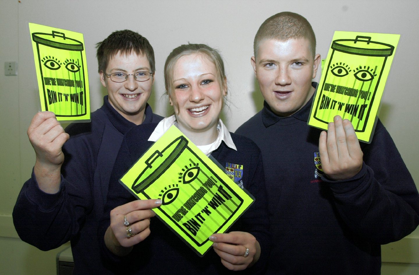 Inverurie Academy pupils posing for photos holding anti-littering leaflets