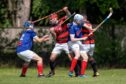 Glenurquhart's John Barr (centre left) and Kyles' James Pringle (centre right) in the thick of the action.