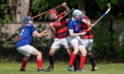 Glenurquhart's John Barr (centre left) and Kyles' James Pringle (centre right) in the thick of the action.