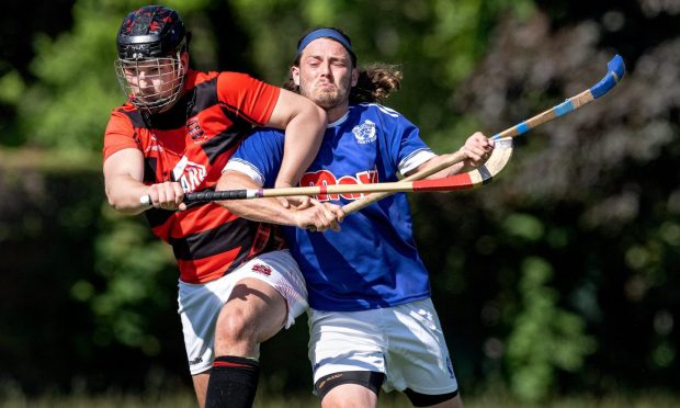 No quarter given: Oliver Black (Glenurquhart) with Andrew King (Kyles), right. Image: Neil G Paterson.