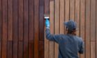 Woman painting fence