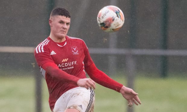 23 Decemeber 2023. Deveronvale FC, Banff, Aberdeenshire, Scotland. This is from the Breedon Highland League Match between Deveronvale FC and Clachnacuddin FC. PICTURE CONTENT:- Deveronvale - Innes McKay clears                                   CREDIT - JASPERIMAGE