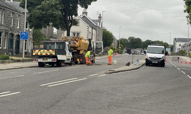 Workmen on Westburn Road. Image: Ross Hempseed/ DC Thomson