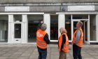 Volunteers looking at the empty units on 225 and 227 Union Street, which have been done up.