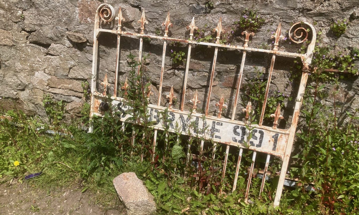 Old St Bryde 991 gate propped up against wall.